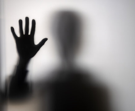 Hands behind a glass