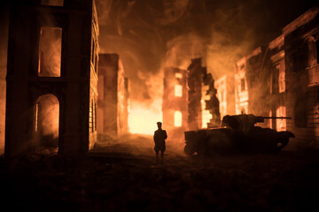 War Concept. Military silhouettes fighting scene on war fog sky background, World War Soldiers Silhouette Below Cloudy Skyline At night. Battle in ruined city.