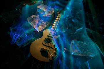 Music Concept: Guitar Miniature on a Dark Background with Vivid Light, Smoke, and Fire Effects. Golden electro guitar under a Dramatic Spotlight.