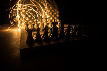 Chess board game concept of business ideas and competition. Chess figures on a dark background with smoke and fog.