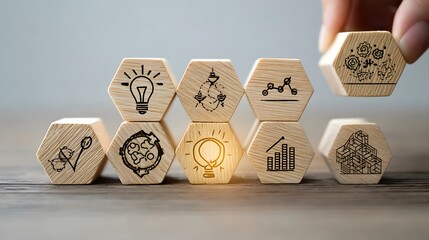 Design Thinking Process concept. Wooden blocks with icons; the key stages of the design thinking process, a solution-focused, problem-solving methodology used for innovation and strategic .