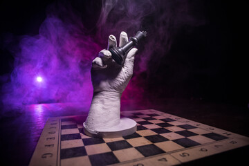 Chess board game concept of business ideas and competition. Chess figures on a dark background with smoke and fog.