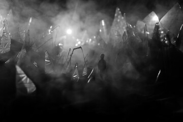 A silhouette of a person against the background of shattered glass. An abstract world made of glass shards. Surreal concept. Table top decoration.