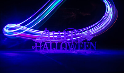 Halloween concept. Creepy silhouette in the dark corridor with pumpkin head. Toned light with fog on background.