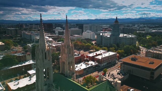 Descending at the beautiful building of the Cathedral Basilica of Denver, Colorado, USA. Cloudy sky at backdrop.