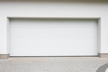 Designer entrance gate to garage. Modern design. Luxurious exterior. Facade of a modern garage.