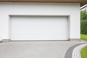 Designer entrance gate to garage. Modern design. Luxurious exterior. Facade of a modern garage.