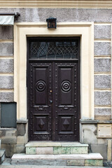 Designer entrance door to a country house. Modern design. Luxurious exterior. Facade of a modern building with modern doors.