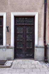 Designer entrance door to a country house. Modern design. Luxurious exterior. Facade of a modern building with modern doors.
