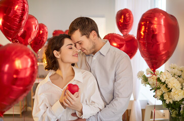 Happy couple in love enjoy romantic atmosphere during St Valentines Day express affection embrace...