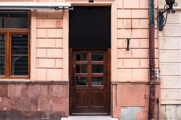 Designer entrance door to a country house. Modern design. Luxurious exterior. Facade of a modern building with modern doors.