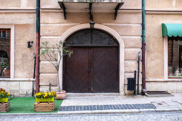 Designer entrance door to a country house. Modern design. Luxurious exterior. Facade of a modern building with modern doors.