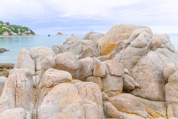 Coastal Rocks by the Sea: Textured rock formations stretch along the tranquil coastline, gazing out over the vast, serene sea. Soft pastel-colored boulders add a gentle touch to the peaceful landscape