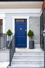 Designer entrance door to a country house. Modern design. Luxurious exterior. Facade of a modern building with modern doors.