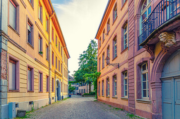 Old town Mulhouse city historic centre with narrow pedestrian street, old colorful buildings, typical multicolored houses, Alsace Grand Est region, France