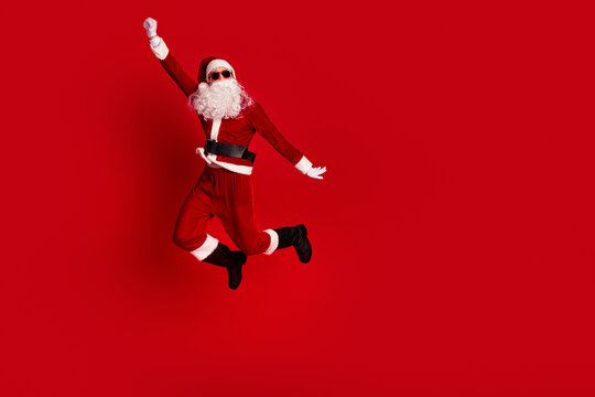 Santa leaps in a red suit against a bold red background delivering festive energy for Christmas and New Year campaigns