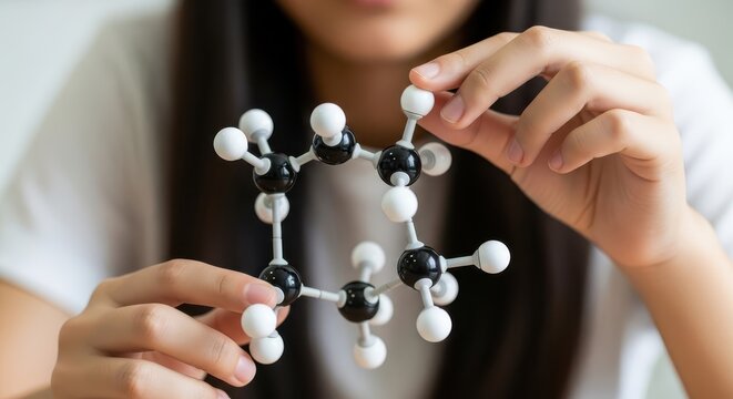 Close-up of Student or Scientist Holding a Molecular Model of an Organic Compound like Benzene