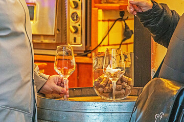 Drinking white wine by the glass and mulled wine at a street fair