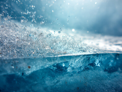 Close-up view of sparkling ice crystals and water droplets frozen on a bright blue frozen surface capturing the essence of winter chill and frost textures