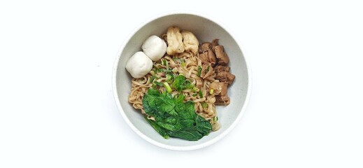 Mie Ayam Indonesian Chicken Noodle Soup with Fish Balls in a Bowl Isolated on White Background. Food Photography