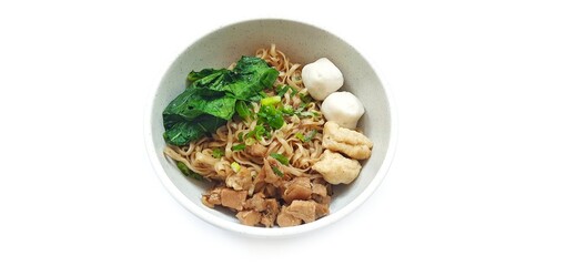 Mie Ayam Indonesian Chicken Noodle Soup with Fish Balls in a Bowl Isolated on White Background. Food Photography