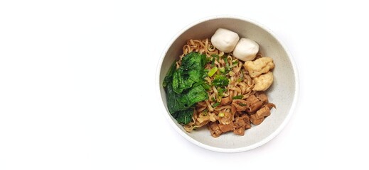 Mie Ayam Indonesian Chicken Noodle Soup with Fish Balls in a Bowl Isolated on White Background. Food Photography
