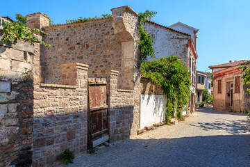 Historic stone buildings and narrow street in quaint village setting