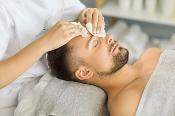 Close-up of professional cosmetologist or beautician doctor hands making beauty procedures cleaning...