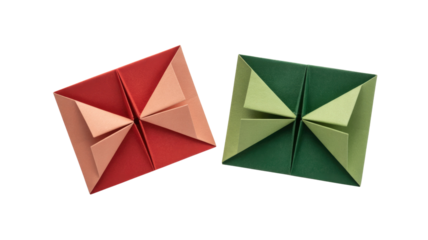 Two striking modular origami pieces, one red and peach, the other green, showcase precise paper folding against a solid dark background. background removed