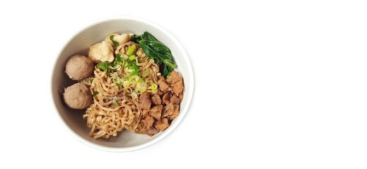 Mie Ayam, Indonesian Chicken Noodle Soup with Meatballs in a Bowl Isolated on White Background