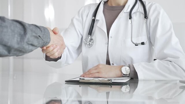 Doctor and patient hands shaking, symbolizing trust, agreement, healthcare partnership, successful consultation, and medical service. Medicine and health care