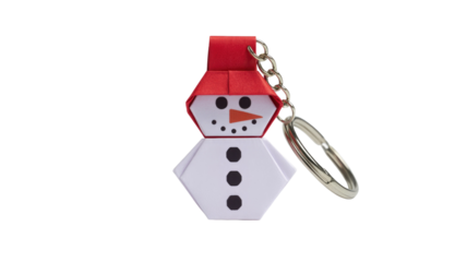 A delightful origami snowman keychain featuring a red hat, black eyes, and an orange carrot nose, perfect for festive winter charm. background removed