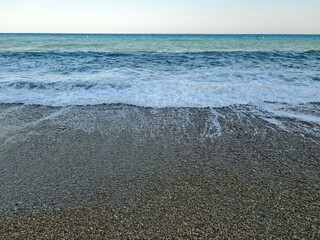 calm horizon over rocky shore with soft waves enhances peaceful atmosphere for meditation and yoga