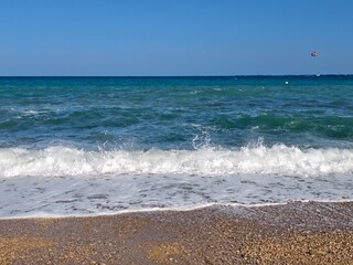 azure coast visuals, scenic seaside with shimmering water, beautiful azure sea meets pebbled