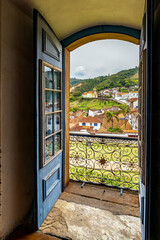 The city of Ouro Preto viewed through the doorway of one of its historic Baroque churches.