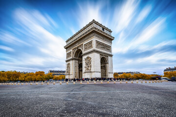Long exposure day view of the Arc de Triomphe in Paris, France, during a sunny autumn day