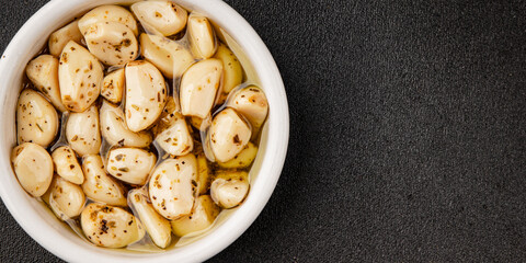 Garlic slices in flavored oil roasted garlic slice in oil fast food natural tasty appetizer fresh delicious gourmet food background on the table rustic top view copy space vegetarian or vegan food