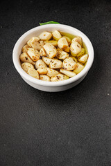 Garlic slices in flavored oil roasted garlic slice in oil fast food natural tasty appetizer fresh delicious gourmet food background on the table rustic top view copy space vegetarian or vegan food