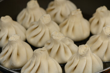 Fresh khinkali close-up. Traditional Georgian dish, appetizing and tasty, homemade kitchen.