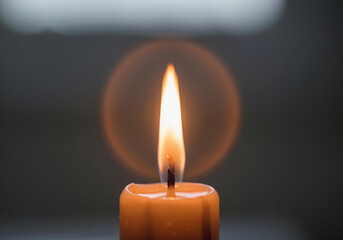 Candle flame burning in dark creating warm light