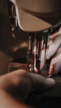 Defocused shot of professional man tailor working with fabric and pattern in his work shop, tracking shot