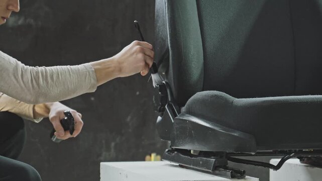 Person works diligently to clean car seat, focusing on removing dirt and stains. Each step shows effort for spotless finish, ensuring cozy ride.