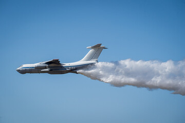Large Aircraft Dispersing Water for Firefighting