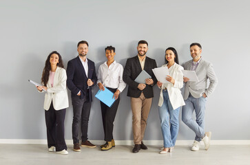 Happy business people team standing in row together with smiles, international professional group...