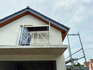 Home renovation project showcases scaffolding and fresh construction details in a residential...