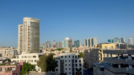 Tel Aviv, Israel, 28 October 2025. An elevated view of a densely built urban landscape combining contemporary skyscrapers with older city buildings, with the round Moshe Aviv Tower standing out on the