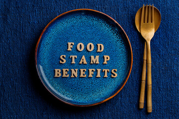 The inscription on the blue plate about food stamp benefits, close up. The Supplemental Nutrition Assistance Program, known as the Food Stamp Program, is a United States federal government program