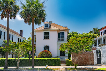 Tall palm trees and historic buildings in the old part of Charleston, South Carolina.