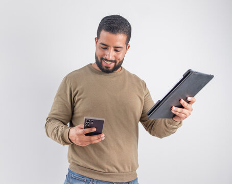 Smiling Man Comparing Devices and Data
