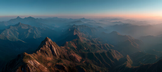 Serene mountain landscape at sunrise with misty blue and pink tones